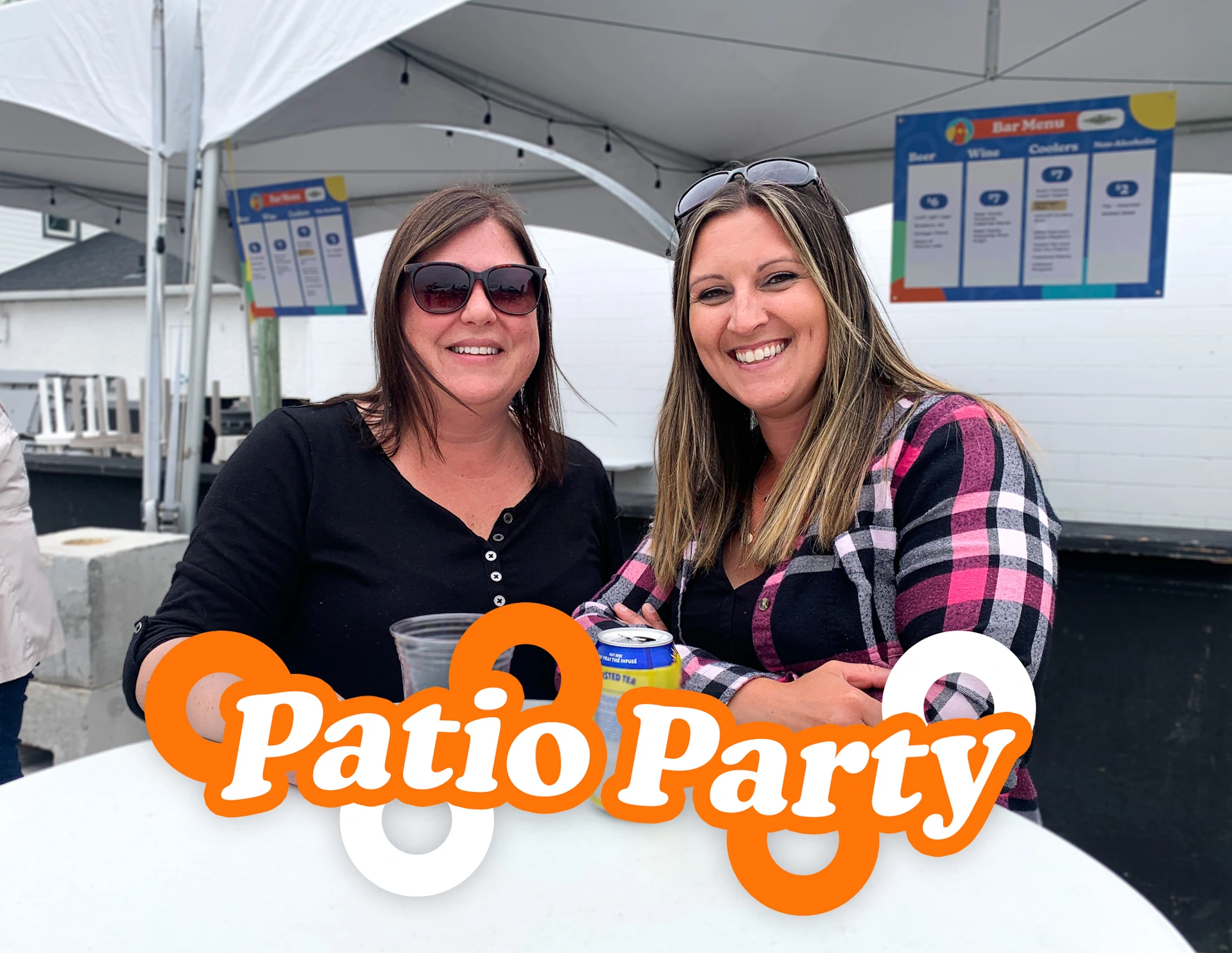 Two women enjoying drinks on patio